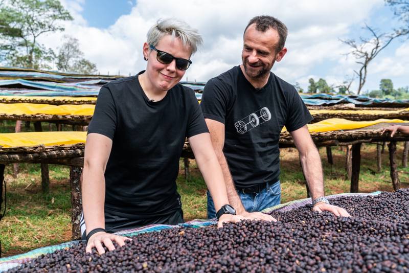 Photograph by Jeff Hann: Sasa Sestic and Agnieszka Rojewska feeling coffee cherry on drying beds in Ethiopia